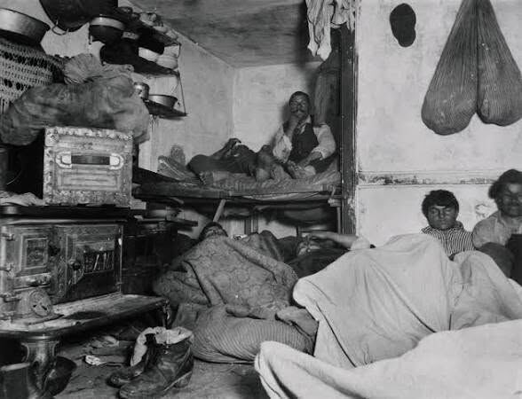 Crowded tenement room in New York, from How the Other Half Lives